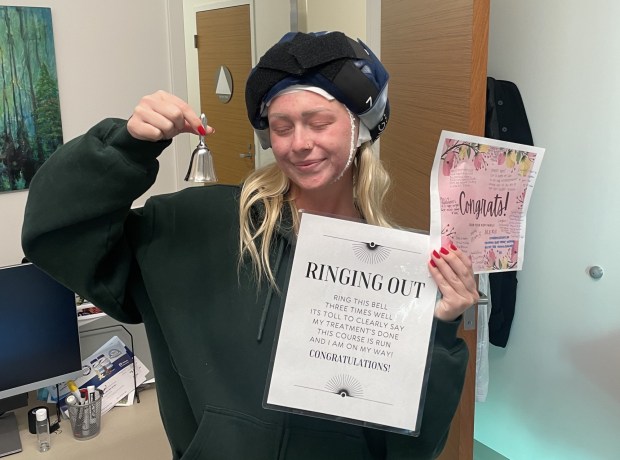 Alexis Klimpl ringing the bell to celebrate the conclusion of her six chemotherapy treatments due to breast cancer. (Courtesy of Alexis Klimpl)