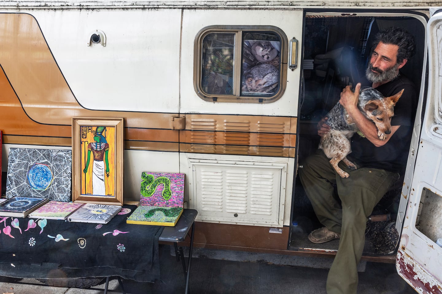 Anan Joshua Adam with his dog in his van.