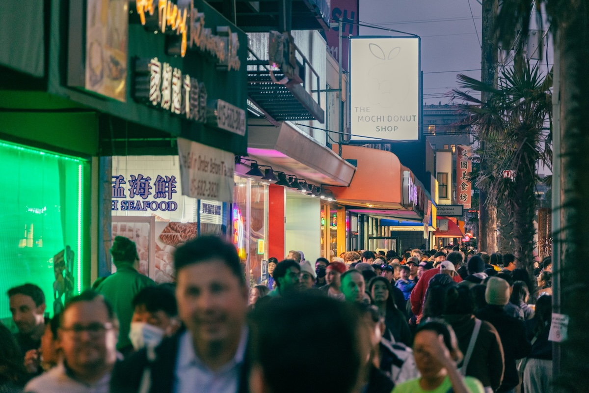 a large crowd of people at a night market in SF