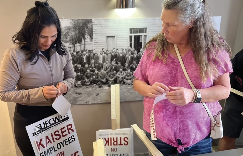 Workers prepare picket signs
