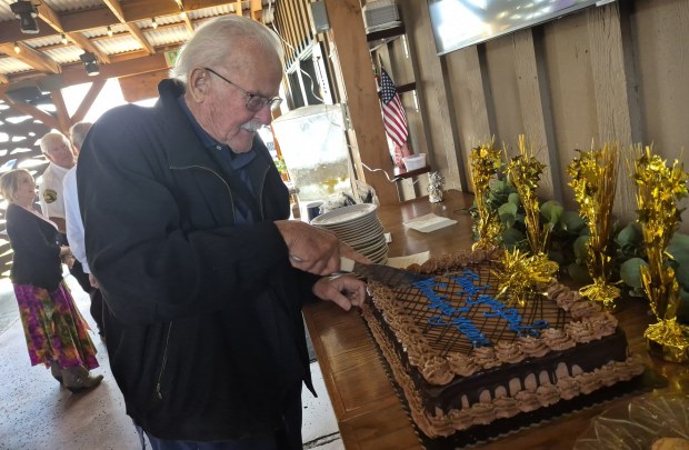 Bill Hicks is shown cutting his celebration cake during a retirement party at D'Carlos Restaurant. (Courtesy Danna Atkins)