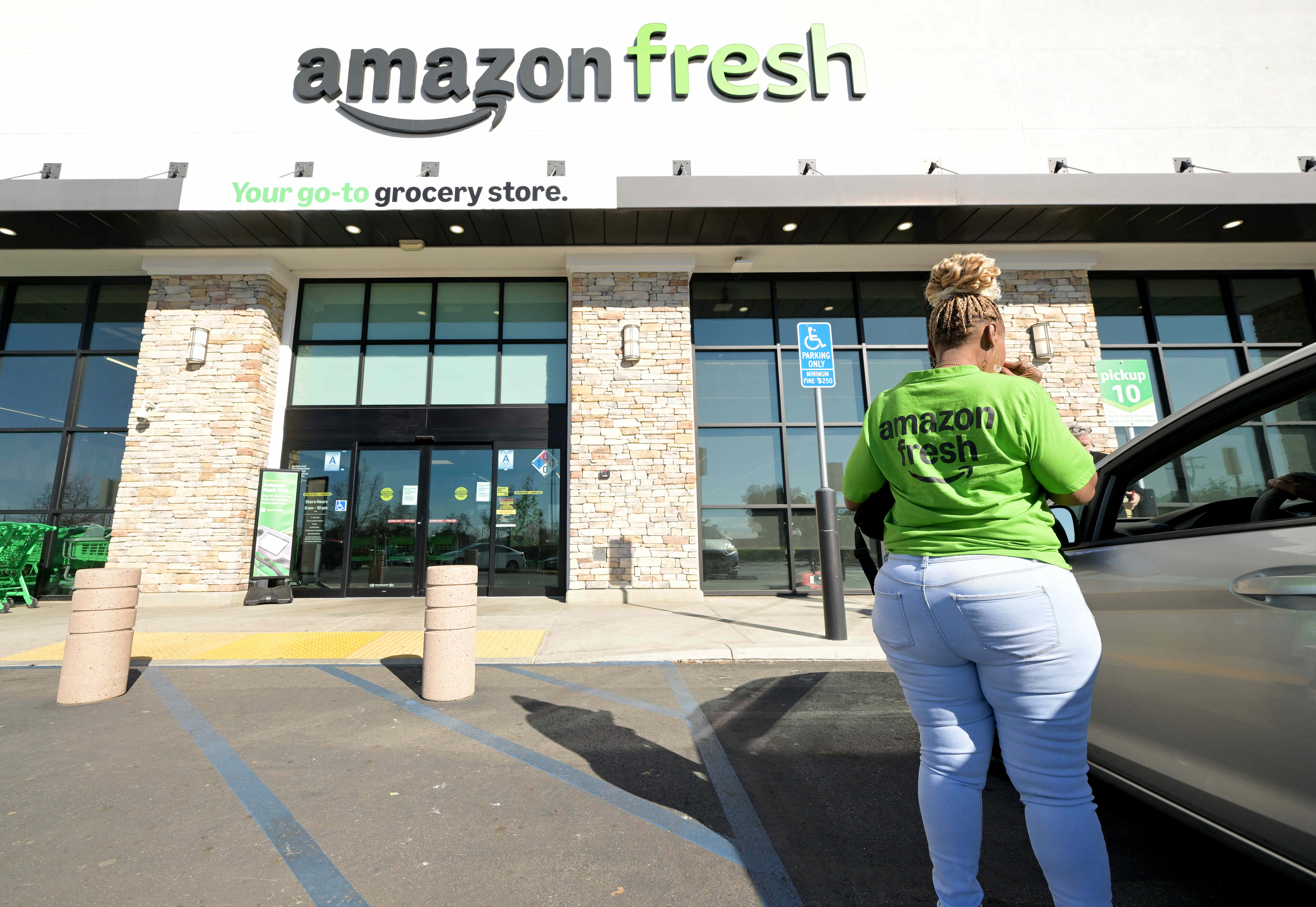 Amazon Fresh employee La Ronda Wallace stands outside the closed...