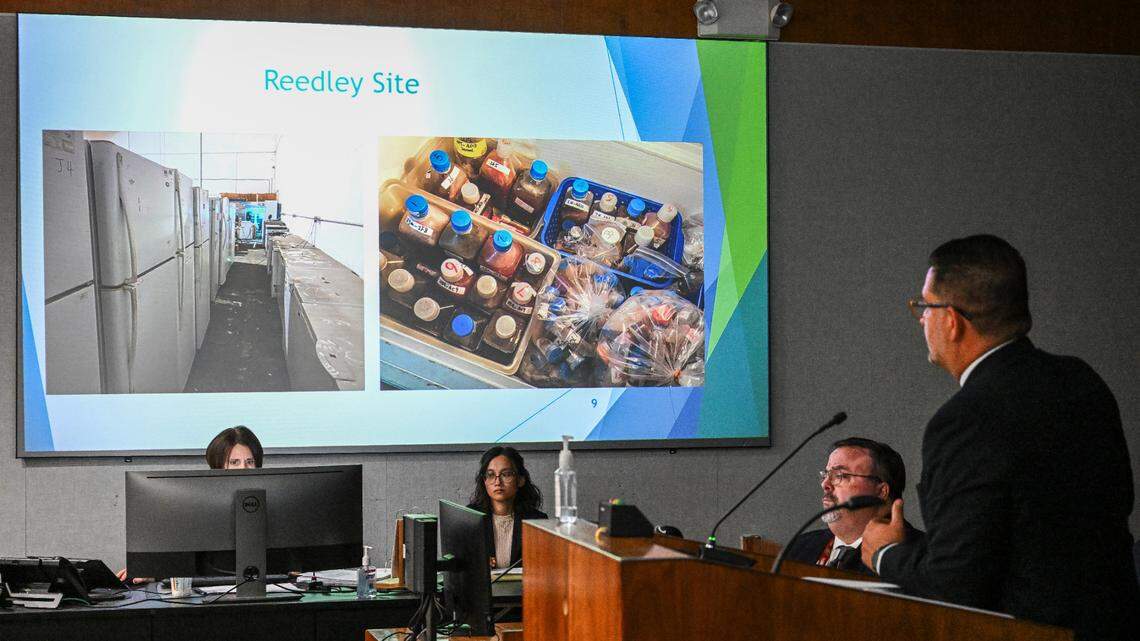 Fresno County Assistant Director of Public Health Joe Prado, right, projects images of refrigerators, freezers and various liquids found in a Reedley warehouse run by a Chinese-owned company under investigation for operating illegally, during a timeline presentation at the Fresno County Board of Supervisor’s meeting on Tuesday, Aug. 8, 2023.