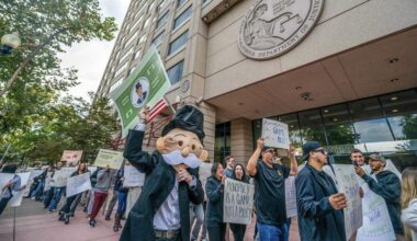 Jackson McFetridge, dressed as Mr. Monopoly, joins card room employees and union members protesting outside Attorney General Rob Bonta’s Sacramento office on Wednesday, Oct. 22, 2025, against proposed regulations that would effectively ban blackjack-style games and severely limit player-dealer games in California card rooms.