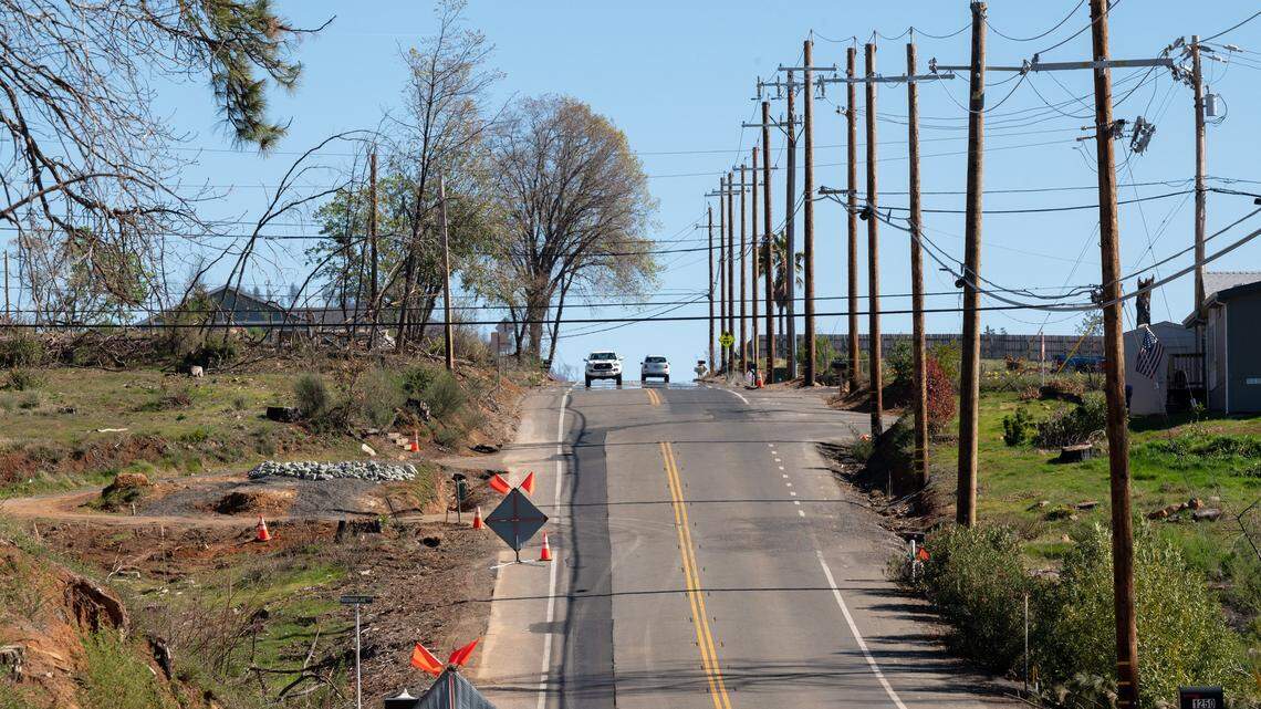 Newly install underground utilities are marked with new asphalt after PG&E crews installed the utilities along Pearson Road on Thursday, Feb. 17, 2022 in Paradise.