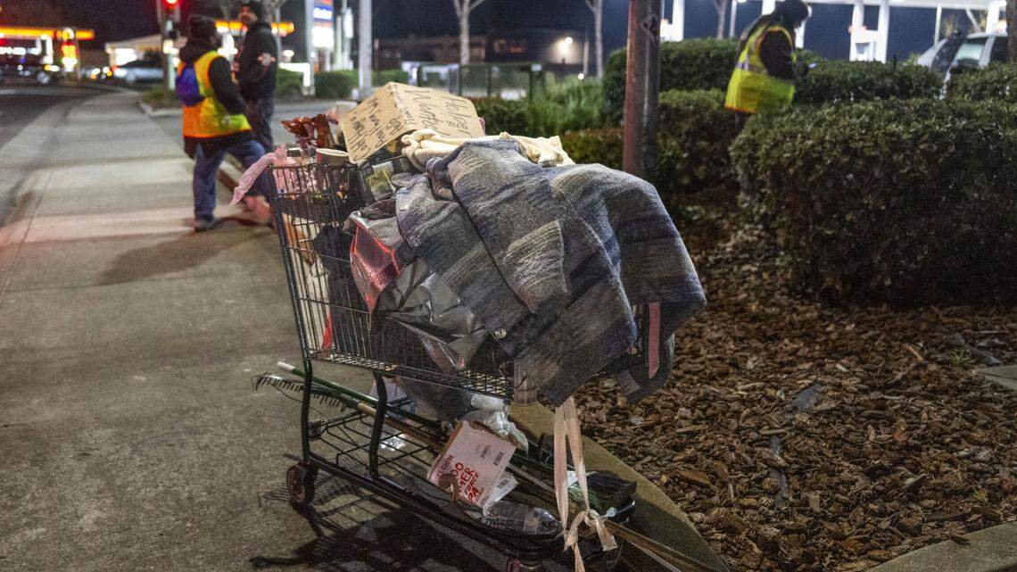 A shopping cart holding the belongings of a homeless person is parked on the sidewalk near Watt Avenue during the Sacramento County Point-in-Time homeless count on Monday, Jan. 26, 2026. The survey is conducted every two years in an attempt to measure the number and demographics of the county's homeless population.