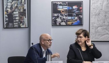 Steven Yarbrough, chair of the State 911 Advisory board, speaks with Cal OES Chief Deputy Director of Policy and Administration Lisa Mangat during a board meeting on Wednesday, Nov. 19, 2025 in Sacramento.