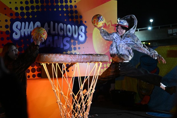 Zhijie Zhang, from Boston, slams a basketball into a giant hoop at the Shaqalicious Slams display during Shaq's Funhouse at the Cow Palace in Daly City on Friday, Feb. 6, 2026. (Chris Riley/Times-Herald)
