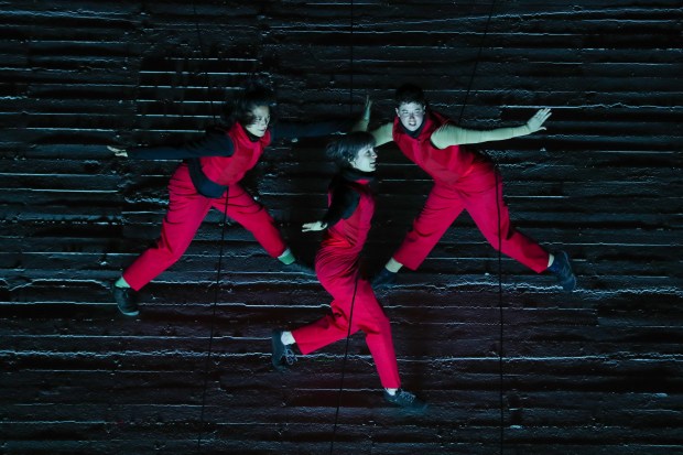 BANDALOOP vertical dancers Sarah Keeney, left, Courtney Moreno and Becca Dean perform during a rehearsal of the new show titled "Loom:Field" directed by Melecio Estrella, as part of their 30th anniversary on the Breuner building wall on West Grand Avenue in Oakland, Calif. in 2022. (Ray Chavez/Bay Area News Group)