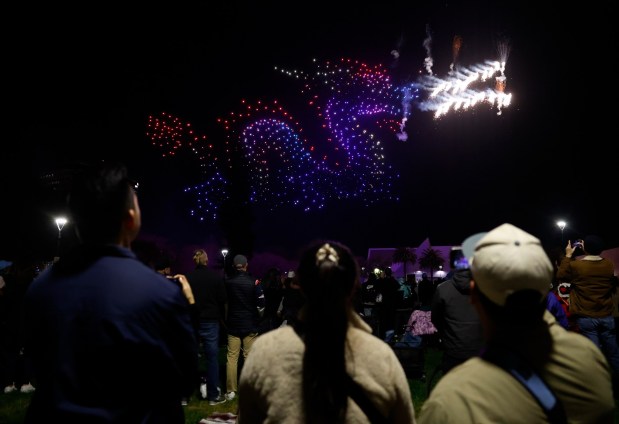 People watch a drone show which depicts a dragon in Discovery Meadow on Super Bowl Opening Night in downtown San Jose, Calif., on Monday, Feb. 2, 2026. (Nhat V. Meyer/Bay Area News Group)
