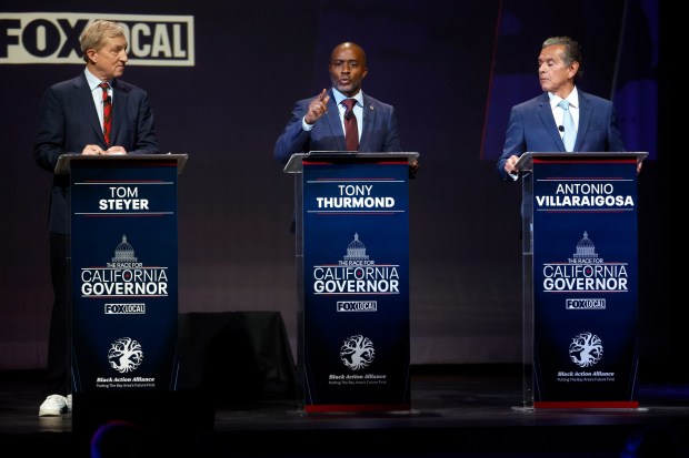 Gubernatorial candidate Tony Thurmond, center, California's state superintendent of public instruction, speaks as Tom Steyer, left, entrepreneur, and Antonio Villaraigosa, former Los Angeles mayor, listen during "The Race for California Governor" gubernatorial debate presented by the Black Action Alliance at The Bayview Opera House in San Francisco, Calif., on Tuesday, Feb. 3, 2026. (Nhat V. Meyer/Bay Area News Group)