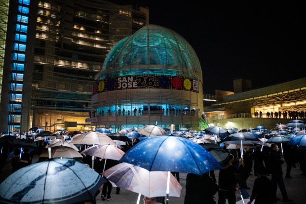 A general view as participants march with umbrellas printed with aerial photographs at City Hall in San Jose, Calif., on Saturday, Jan. 31, 2026. (Thien-An Truong for Bay Area News Group)