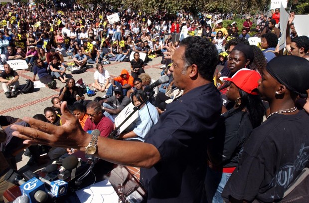 Activist Jesse Jackson, middle, joins college students for a rally against Proposition 54 and the California recall election on the campus of the University of California in Berkeley, Calif. on Tuesday, Sept. 16, 2003. Proposition 54, if passed, will prohibit the collection of data on race, ethnicity, color and national origin by California state and local agencies. Jackson was in the San Francisco Bay Area campaigning in favor of Governor Gray Davis and against the recall. (AP Photo/Marcio Jose Sanchez)