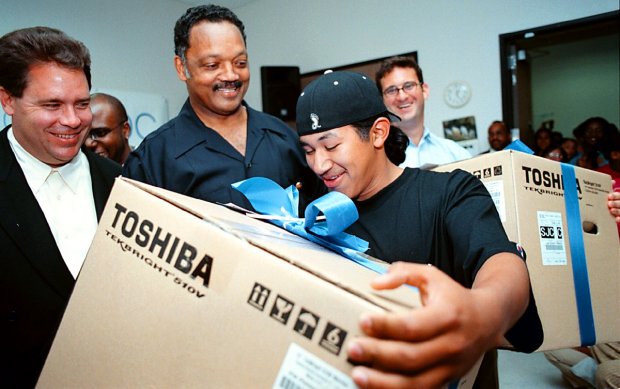  In May of 2000, Florencio Flores, 18, of East Palo Alto, met Jesse Jackson and took home a personal computer courtesy of Jackson's Rainbow/PUSH Coalition and its corporate partners. Flores was one of 25 East Palo Alto youths who received computers from the Rainbow/PUSH Coalition. (Bret Putnam/ San Mateo County Times Archives) 