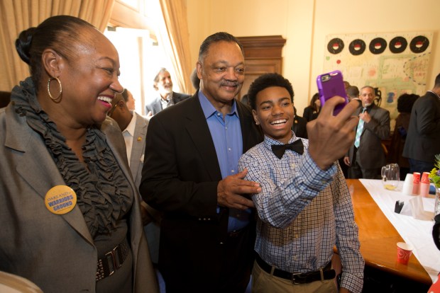 Fifteen-year-old George Hofstetter of San Leandro, Calif., right, photographs himself with The Rev. Jesse Jackson during a ceremony at Oakland City Hall, Thursday, Feb. 25, 2016, in which the Golden State Warriors presented a championship ring to Mayor Libby Schaaf and the city of Oakland, Calif. Jackson had just concluded a meeting with Schaaf, and availed himself of the opportunity to share in the festivities. (D. Ross Cameron/Bay Area News Group)