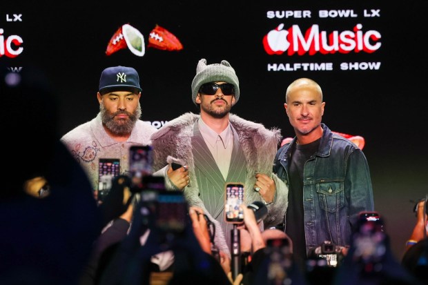 Super Bowl Halftime Show superstar Bad Bunny, center, stands with Apple Music Radio hosts Ebro Darden, left, and Zane Lowe after a Super Bowl LX pregame and Apple Music Halftime Show press conference at Moscone Center in San Francisco, Calif., on Thursday, Feb. 5, 2026. (Ray Chavez/Bay Area News Group)