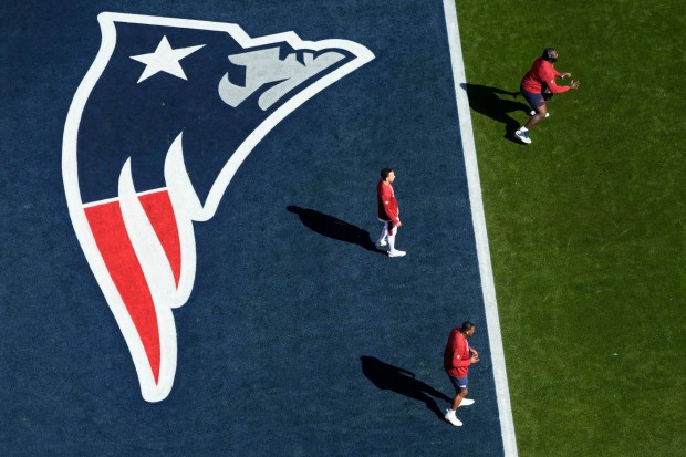 New England Patriots players stretch before the NFL Super Bowl 60 football game against the Seattle Seahawks, Sunday, Feb. 8, 2026, in Santa Clara, Calif. (AP Photo/Godofredo A. Vásquez)