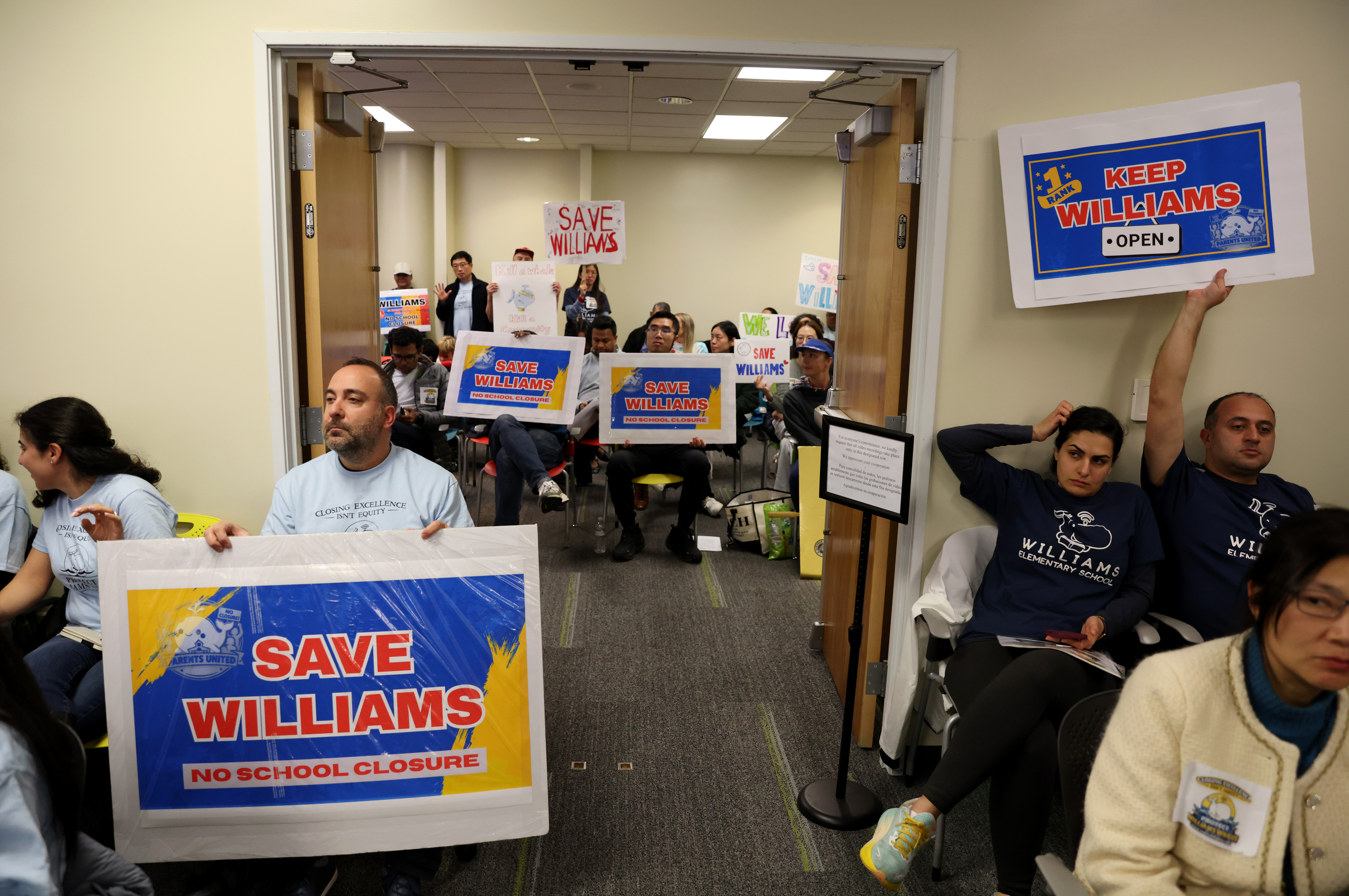 An overflow crowd of community members attend a meeting at...