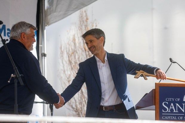 John Poch, San Jose Sports Authority's Executive Director, shakes hands with San Jose Mayor Matt Mahan, right, during the State of the City Address at San Pedro Square Market in downtown San Jose, Calif., on Saturday, Feb. 7, 2026. (Shae Hammond/Bay Area News Group)