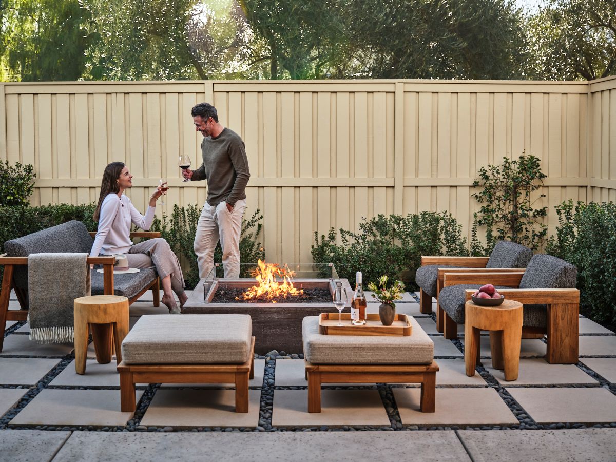 couple interacts beside modern firepit at the Solage hotel