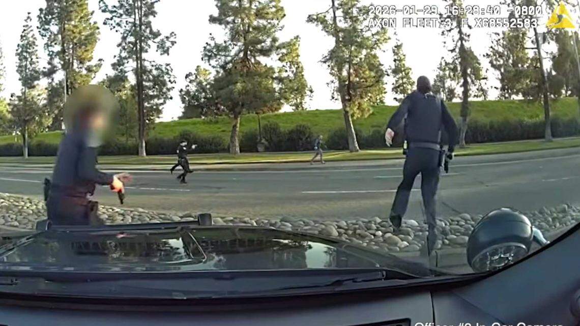 A police vehicle’s dash camera captures officers chasing a bank robbery suspect on Exposition Boulevard in the Point West neighborhood of Sacramento on Thursday, Jan. 29, 2026. Police said two officers fired six shots after the man turned and pointed what was later determined to be an imitation firearm.