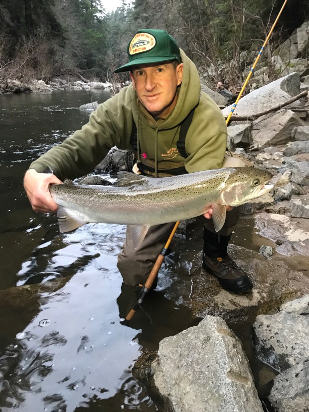 Santa Cruz angler Michael Baxter, a member of the Board of Directors for the Monterey Bay Salmon & Trout Project, poses with one of the many steelhead he's caught and released in the San Lorenzo River. (Contributed)