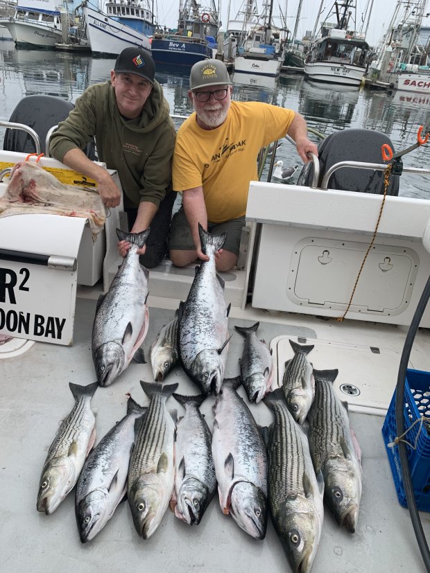 Santa Cruz anglers Mike Baxter, left, and Allen Bushnell cherish a rare, but satisfying day after catching limits of salmon and stripers on a trip to Half Moon Bay in 2019. (Contributed)