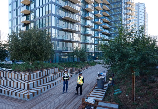 Cole Smith, left, and Brent Schertzer of Holland Partner Group, stand on a 9th-floor deck at The Torrey, a 34-story, 450-unit luxury residential tower in downtown. (K.C. Alfred / The San Diego Union-Tribune)