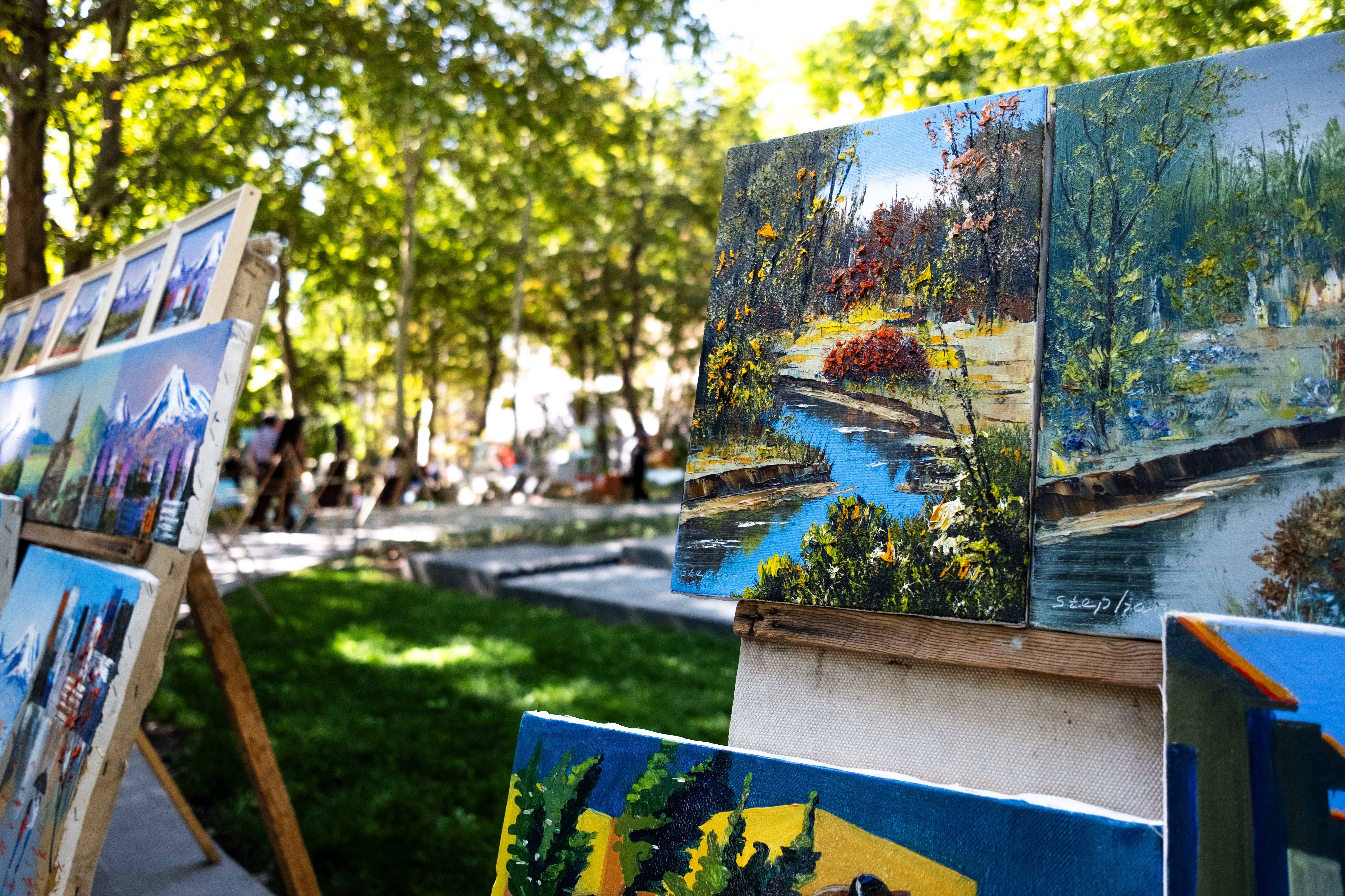 In Saryan Square, artists set up easels and brush color...