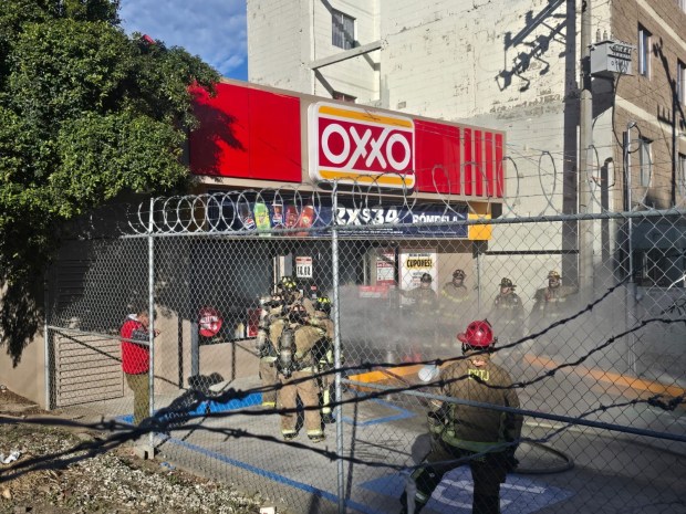 Firefighters extinguish a fire that was set to a convenience store in Tijuana on Feb. 22 amid a series of violent attacks following the killing of "El Mencho." (Tijuana Public Safety Secretariat)