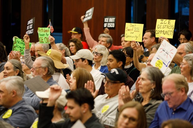 Community members hold up signs in protest against a contract renewal with DHS and the use of the city's firing range at Escondido City Hall on Wednesday, Feb. 25, 2026.(Kristian Carreon / The San Diego Union-Tribune)