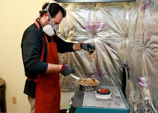 San Diego, CA - February 10: Josh Morelock of Gold Refinery of San Diego puts gold coins and jewelry into a melting furnace to be melted into bars on February 10, 2026 in San Diego, CA. (K.C. Alfred / The San Diego Union-Tribune)