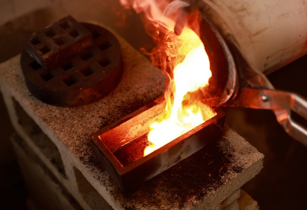 San Diego, CA - February 10: Josh Morelock of Gold Refinery of San Diego puts melted gold coins and jewelry into a form to create bars on February 10, 2026 in San Diego, CA. (K.C. Alfred / The San Diego Union-Tribune)