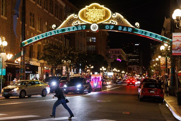 San Diego, California - February 20: A pedestrian crosses the street at the Gaslamp Quarter in downtown San Diego on Friday, February 20, 2026. The street was previously closed to vehicular traffic. (Kristian Carreon / The San Diego Union-Tribune)