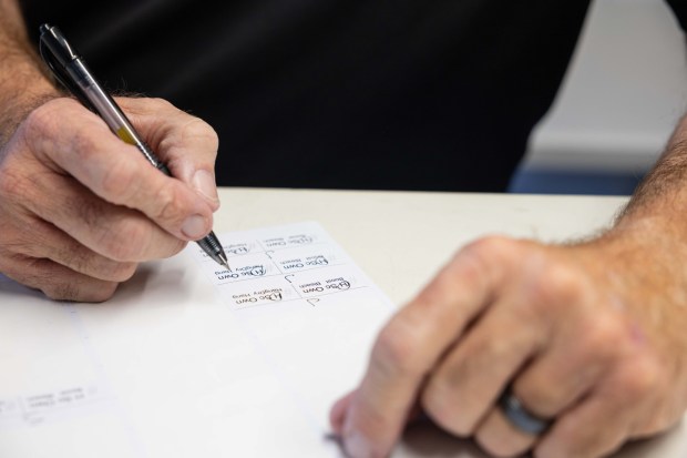 Steve Osterhage makes notes on lables at his at home laundry business in San Diego, Tuesday, Jan. 20, 2026. (Zoë Meyers / For The San Diego Union-Tribune)