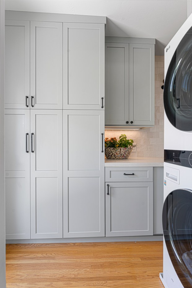 After, Sheryl Chaffee of Ntrada Design used a stackable washer and dryer to open up room for floor-to-ceiling storage space. (Ntrada Design)