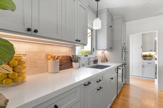 After, the laundry area is as light and bright as the adjacent kitchen. (Ntrada Design)