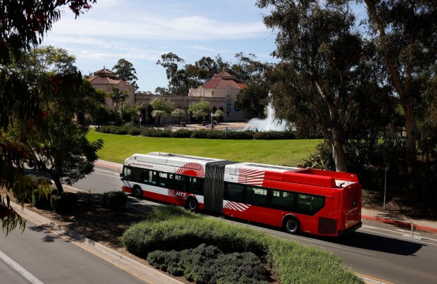 An MTS bus travels along Park Boulevard in Balboa Park with the Fleet Science Center and Bea Evenson Fountain in the background on Feb. 5, 2026, in San Diego. (K.C. Alfred / The San Diego Union-Tribune)