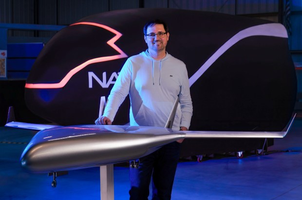 SAN DIEGO, CA - FEBRUARY 13: Aleksey Matyushev, co-founder and CEO of the start-up, Natilus, with a 1/10th scale model of the aircraft, Kona, that has been used for wind tunnel testing, and when the Kona planes start flying, they be used for cargo delivery, and combines both unmanned flight capabilities with remote piloting from the ground. They are also developing a version, called Horizon, to transport passengers. Photographed Friday February 13, 2026, at Brown Field Airport in Otay. Mesa, in San Diego, California. (Howard Lipin / For The San Diego Union-Tribune)
