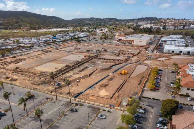 2/18/2026_San Marcos, CA_High angle view looking west of the former site of Old California Restaurant Row along San Marcos Blvd. shown at left. It's now under construction for residential and commercial buildings. In the distance along the west end of the property is Edwards Cinemas theaters. (Charlie Neuman / For The San Diego Union-Tribune)
