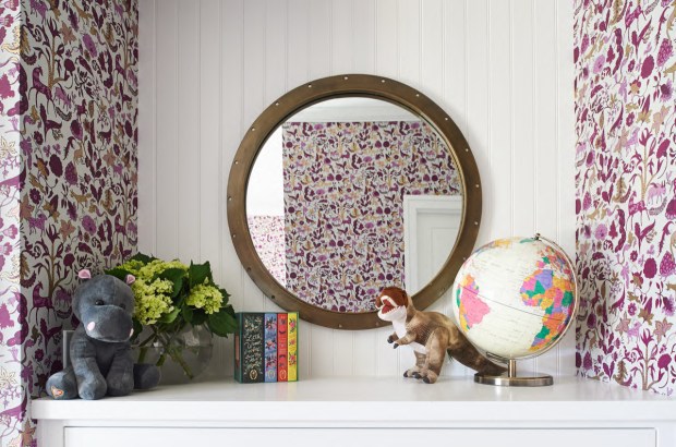 Wall covering in a playfully pink woodland feel brings a cozy vibe to this playroom. (Bungalow 56)