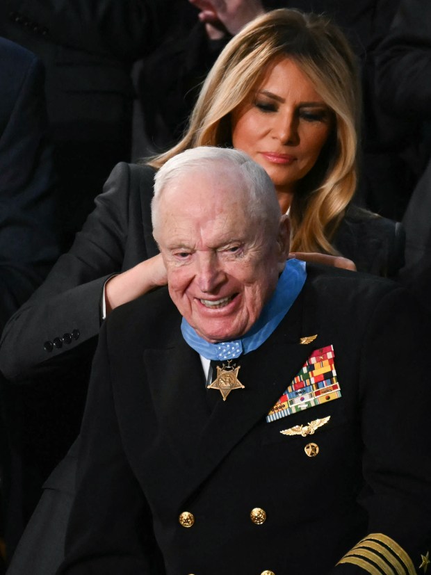 US First Lady Melania Trump presents US veteran Captain E. Royce Williams with the Medal of Honor during US President Donald Trump's the State of the Union address in the House Chamber of the US Capitol in Washington, DC, on February 24, 2026. (Photo by ANDREW CABALLERO-REYNOLDS / AFP via Getty Images)