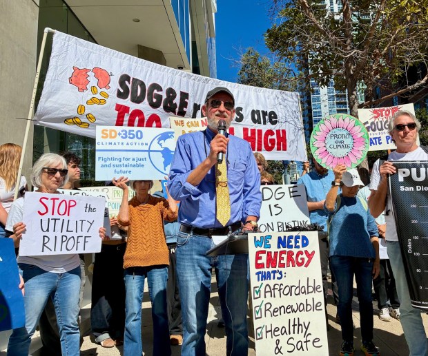 Craig Rose, a member of Public Power San Diego, speaks at a protest in front of Sempra headquarters in downtown San Diego ahead of the release of San Diego Gas & Electric's 2025 profits. About 30 demonstrators gathered on Thursday, Feb. 26, 2026. (Rob Nikolewski/The San Diego Union-Tribune)