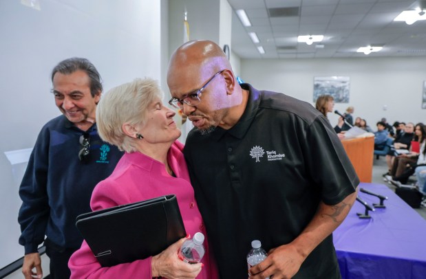 In the jury lounge of the Vista Courthouse convicted murderer Tony Hicks hugs Judge Joan Weber, who presided at his trial, after he spoke to local high school students participating the Youth In Court program. At left is Azim Khamisa, the father of the man Hicks killed, Tariq Khamisa. (Charlie Neuman / For The San Diego Union-Tribune)