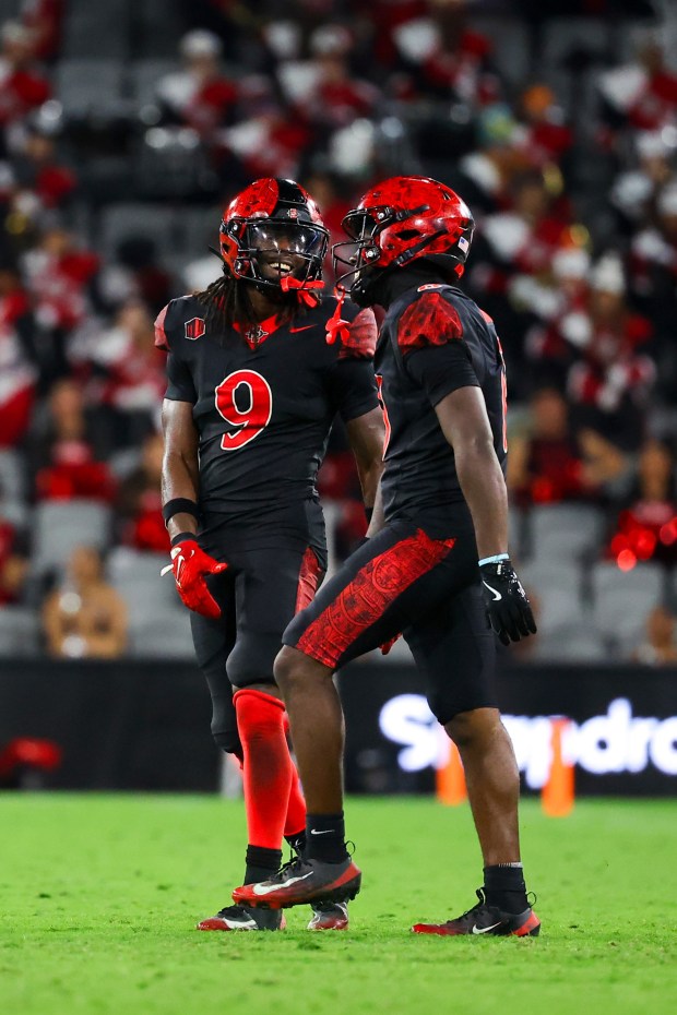 San Diego State safety Dalesean Staley (9) and Bryce Phillips #0 of the San Diego State Aztecs celebrate together on the field during their game against the California Golden Bears at Snapdragon Stadium on Saturday, Sept. 20, 2025 in San Diego, California. (Meg McLaughlin / The San Diego Union-Tribune)