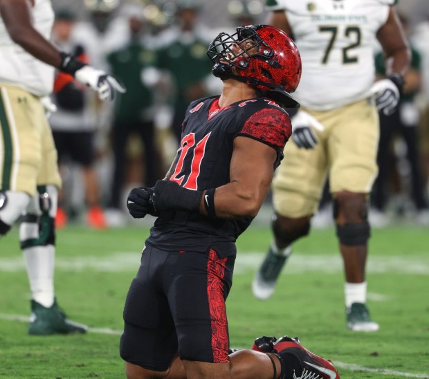 The Aztecs' Tano Letuli celebrates after tackling Colorado State's quarterback Jackson Brousseau in the first quarter at Snapdragon Stadium in San Diego on Friday, Oct. 03, 2025. (Hayne Palmour IV / For The San Diego Union-Tribune)