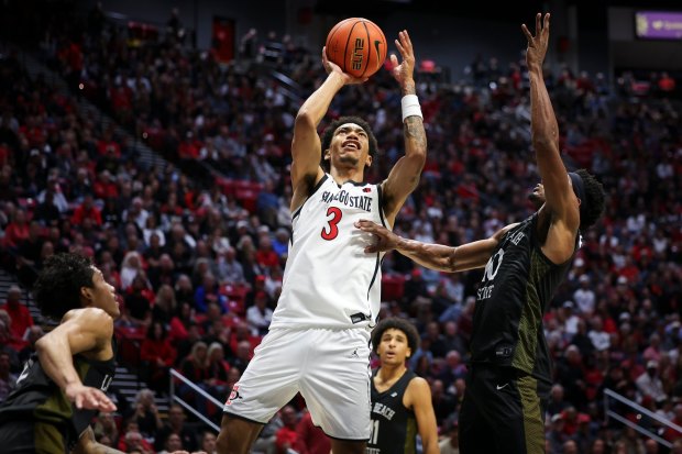 Elzie Harrington #3 of San Diego State takes a shot against Cole Farrell #10 of Long Beach State at Viejas Arena on Tuesday, Nov. 4, 2025 in San Diego, California. (Meg McLaughlin / The San Diego Union-Tribune)