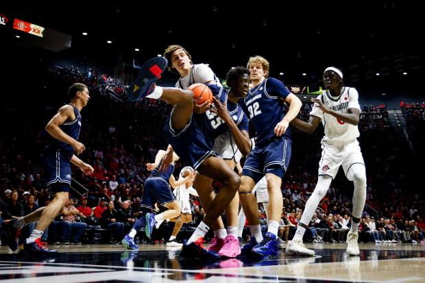 Miles Heide #40 of San Diego State and Adlan Elamin #35 of Utah State vie for the rebound during their game at Viejas Arena on Wednesday, Feb. 25, 2026 in San Diego, California. (Meg McLaughlin / The San Diego Union-Tribune)