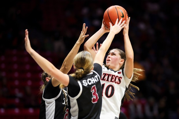 Nat Martinez #10 of San Diego State attempts a shot against Delainey Miller #20 and Kate Schat #3 of Santa Clara during their game at Viejas Arena on Wednesday, Nov. 19, 2025 in San Diego, California. (Meg McLaughlin / The San Diego Union-Tribune)