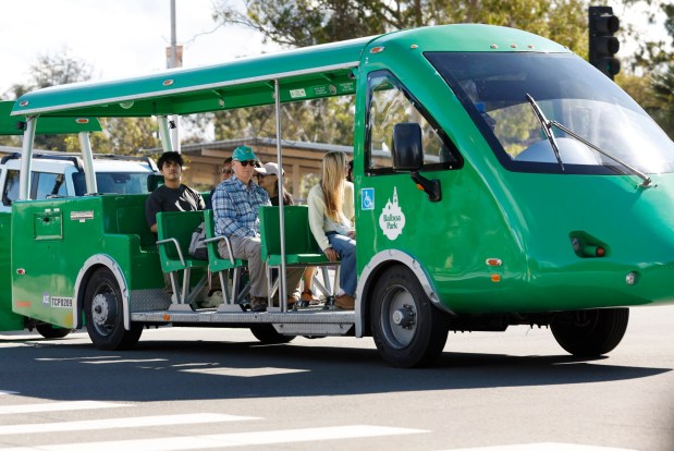 Visitors ride on the free Balboa Park tram on the first day of paid parking in the park on Jan. 5, 2026, in San Diego. (K.C. Alfred / The San Diego Union-Tribune)